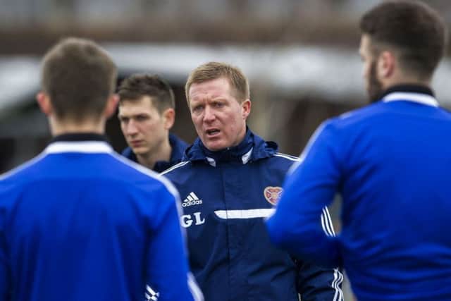 Hearts manager Gary Locke speaks to his squad during training. Picture: SNS