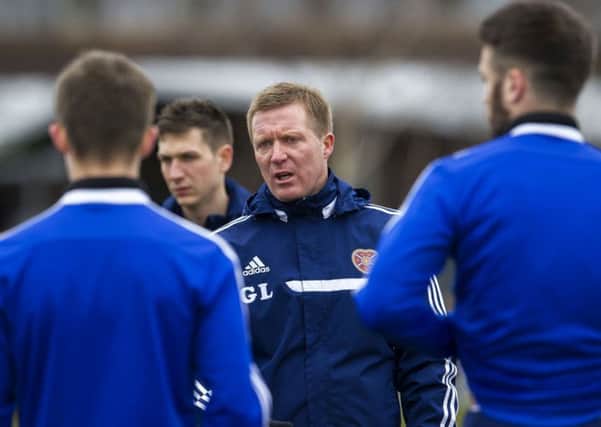 Hearts manager Gary Locke speaks to his squad during training. Picture: SNS