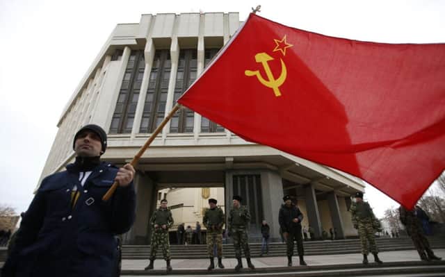 A man holds a Soviet Union flag as he attends a pro-Russian rally at the Crimean parliament building in Simferopol. Picture: Reuters
