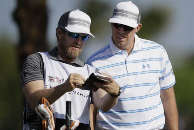 Hunter Mahan, right, listens to his caddie John Wood. Picture: AP