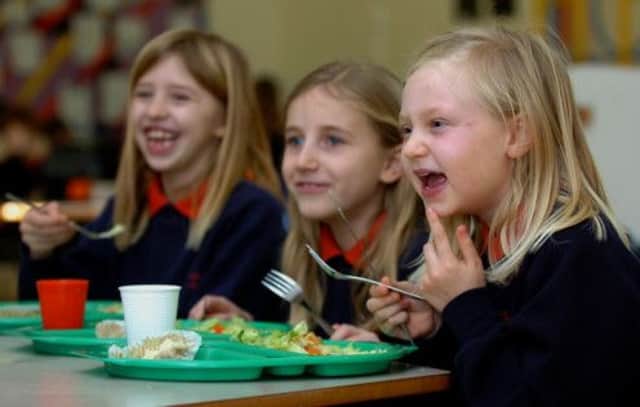 Salmond said children in primaries one, two and three would get free lunches from January 2015. Picture: PA