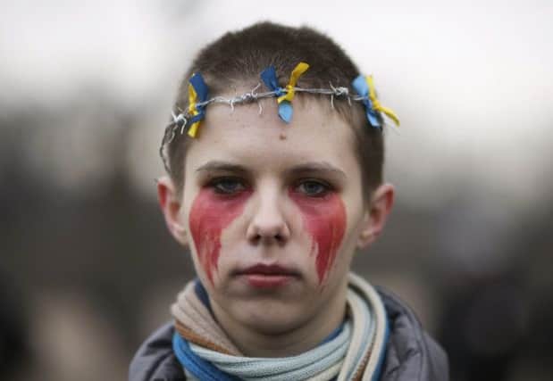 An anti-war protester wears a barbed-wire crown at a demonstration in The Field of Mars, St Petersburg. Picture: Reuters