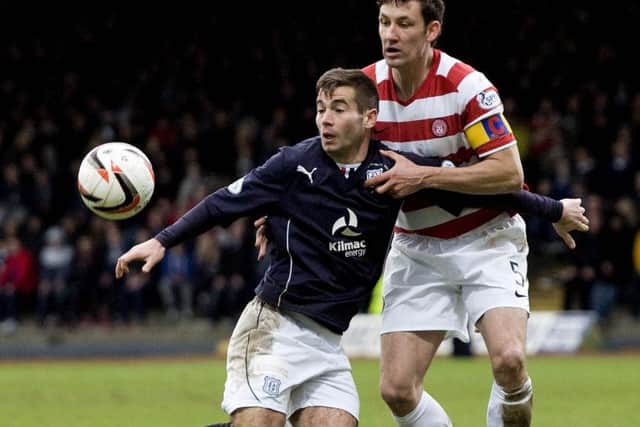 Dundee's Peter MacDonald holds off counterpart Martin Canning (right). Picture: SNS