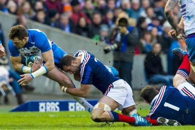 Scotland's Sean Lamont (left) is tackled by Alexandre Lapandry. Picture: SNS