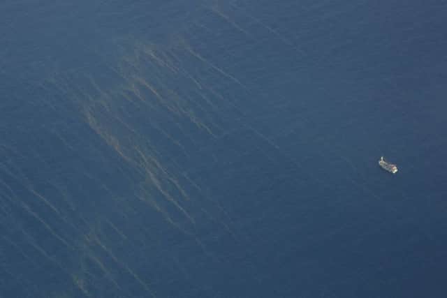 An aerial photograph shows a boat sailing past oil spills off the southern seas of Vietnam where a search operation is underway. Picture: Getty