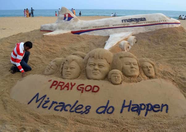A sand sculpture dedicated to the passengers of Malaysian Airlines flight MH270 is seen on Puri, in the eastern state of Odisha, India. Picture: Reuters