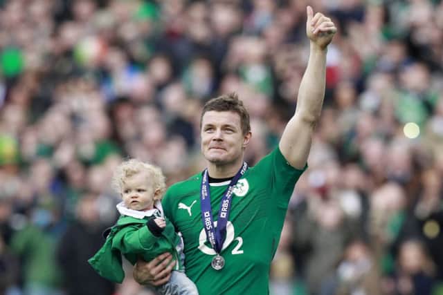Brian O'Driscoll carries his daughter Sadie after his last home appearance for Ireland. Picture: REUTERS/Cathal McNaughton