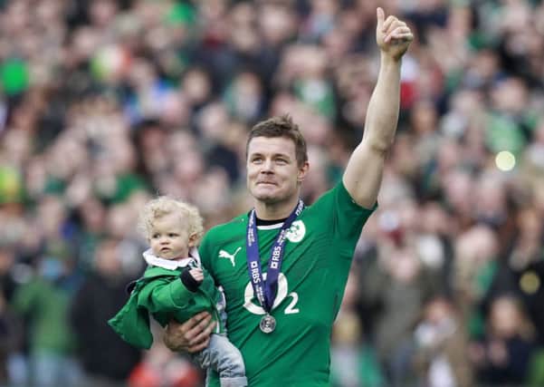 Brian O'Driscoll carries his daughter Sadie after his last home appearance for Ireland. Picture: REUTERS/Cathal McNaughton