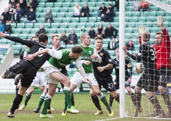 Hibs Michael Nelson squeezing the ball into the Motherwell net. Picture: Ian Georgeson.