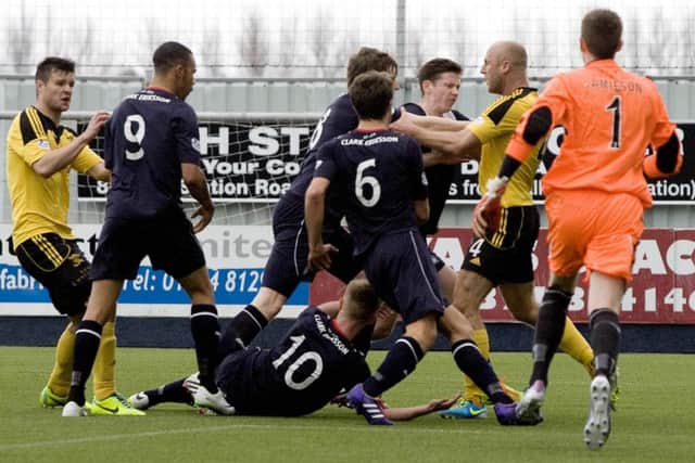 Players confront each other in the box after a penalty was awarded to Falkirk. Picture: SNS