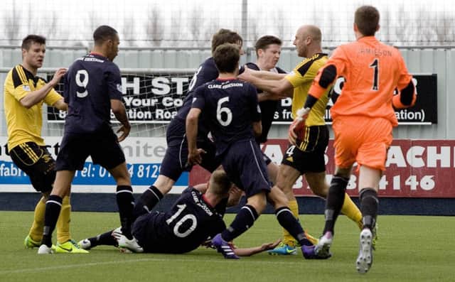 Players confront each other in the box after a penalty was awarded to Falkirk. Picture: SNS