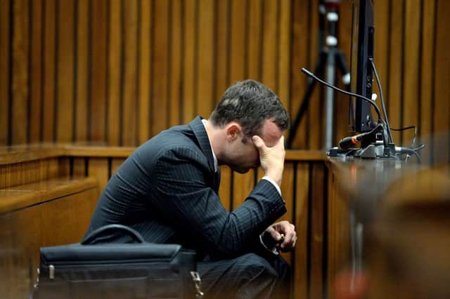 Oscar Pistorius is pictured hunched over in the dock on the sixth day of his trial. Picture: AFP/Getty