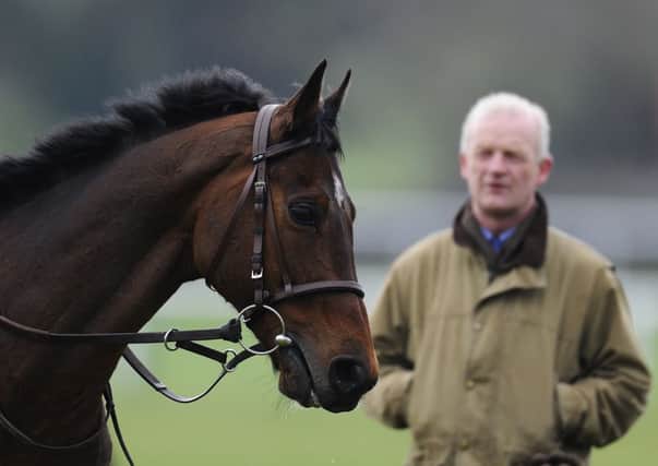 Trainer Willie Mullins watches Hurricane Fly on the gallops at Cheltenham. Picture: Getty