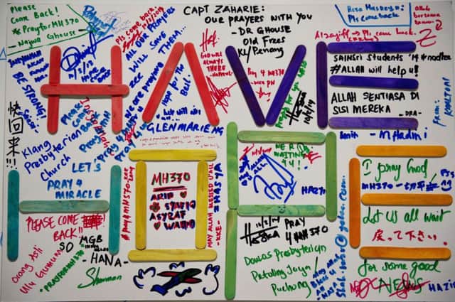 A poster carrying messages for the passengers of the missing Malaysia Airlines flight. Picture: Getty