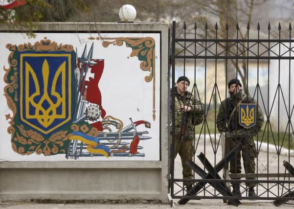Ukrainian troops at a military unit in the village of Perevalnoye in Crimea yesterday. Picture: Reuters