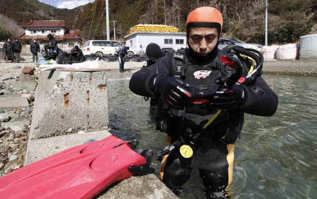 Yasuo Takamatsu is learning to scuba dive in hopes of finding the remains of his wife. Picture: AP