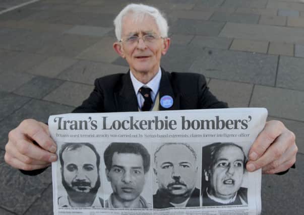 Dr Jim Swire, who lost his daughter in the Lockerbie bombing holds up a copy of the Daily Telegraph. Picture: Ian Rutherford