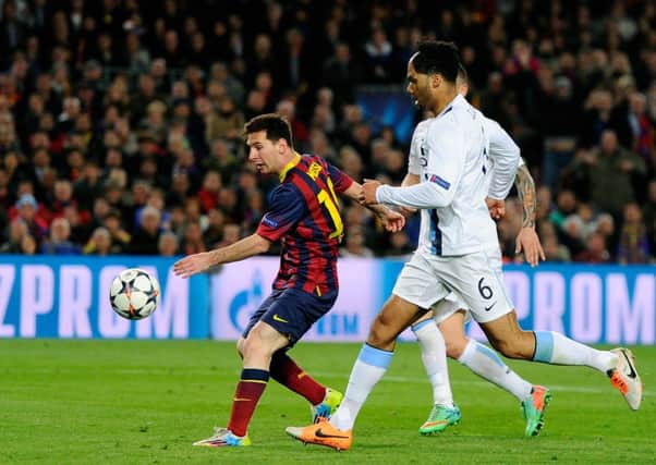 Man City defender Joleon Lescott cant prevent Lionel Messi from opening the scoring. Picture: Getty