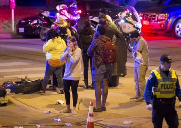 Bystanders look on following the fatal crash at SXSW. Picture: AP (Jay Janner/Statesman.com)