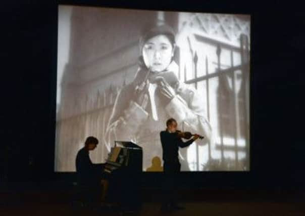 Filmgoers are engaged as musicians interpret the screen images of a silent film with specially composed scores