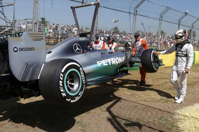 Lewis Hamilton reaches out to touch his car during practice at Albert Park    Picture: Reuters