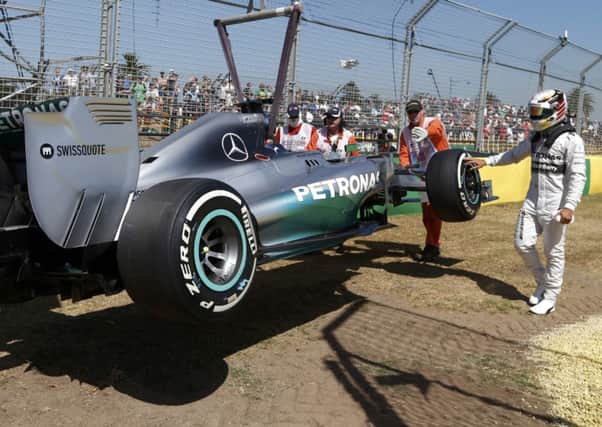 Lewis Hamilton reaches out to touch his car during practice at Albert Park    Picture: Reuters