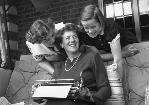 1949: The famous children's author Enid Blyton with her two daughters Gillian (left) and Imogen (right) at their home in Beaconsfield, Buckinghamshire. (Photo by George Konig/Keystone Features/Getty Images)