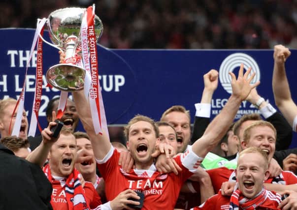 Russell Anderson lifts the Scottish League Cup after Aberdeen won a penalty shoot-out 4-2 against Inverness. Picture: SNS