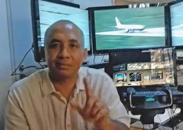 One of the plane's Captains Zaharie Ahmad Shah pictured at his home flight simulator