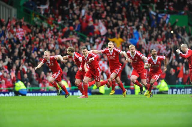 Joy for Aberdeen as Adam Rooney's penalty wins them the cup. Picture: Robert Perry