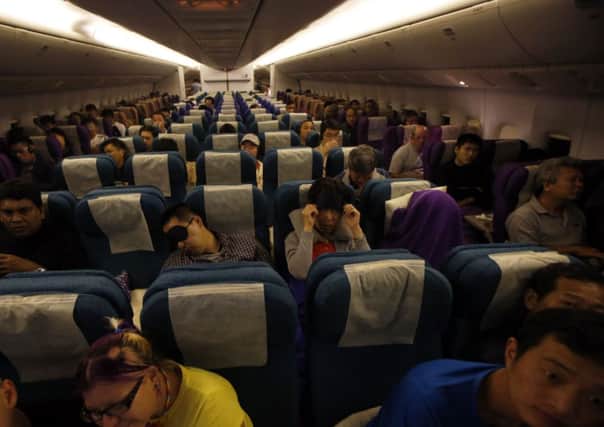 Passengers remain in their seats onboard Malaysia Airlines flight MH318, which replaces flight number MH370 as a mark of respect Picture: Reuters