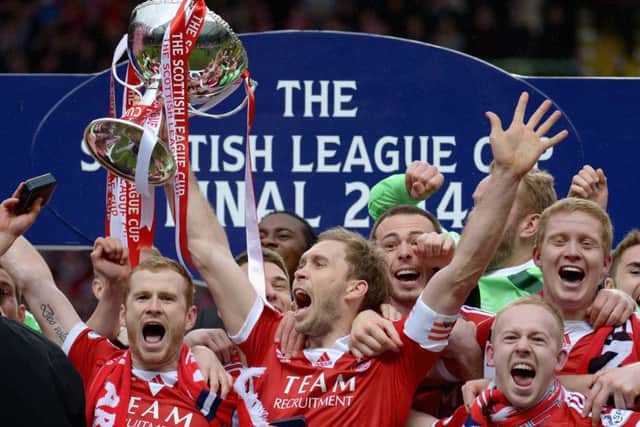 Russell Anderson lifts the Scottish Communities League Cup. Picture: Getty