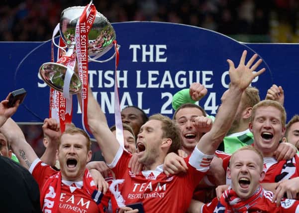 Russell Anderson lifts the Scottish Communities League Cup. Picture: Getty