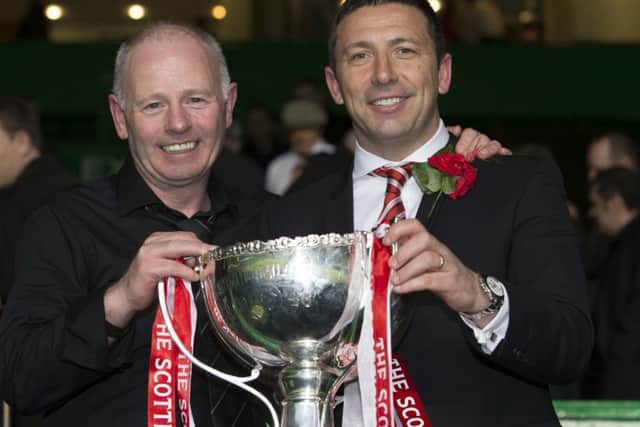 Aberdeen chairman Stewart Milne raises the cup with manager Derek McInnes Picture: PA