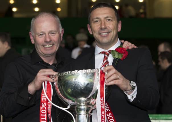 Aberdeen chairman Stewart Milne raises the cup with manager Derek McInnes Picture: PA