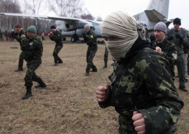 New recruits to Ukraine's military forces learn techniques of unarmed combat during a training session near Kiev. Picture: Getty Images