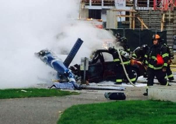 Firefighters attend the scene of the crash. Picture: AP