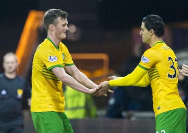 Liam Henderson, left, makes way for Beram Kayal. Picture: SNS