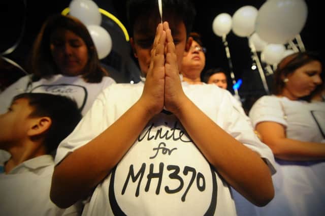 A young Malaysian boy prays at an event for the missing Malaysia Airline, MH370. Picture: AP