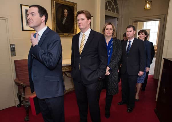 George Osborne, left, and Danny Alexander, centre, prepare to leave 11 Downing Street. Picture: AFP/Getty