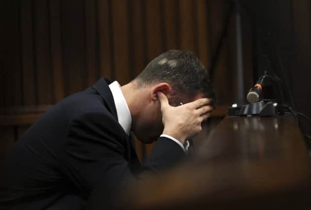 Pistorius pressed his thumbs into his ears during testimony about Reeva Steenkamps wounds. Picture: Reuters