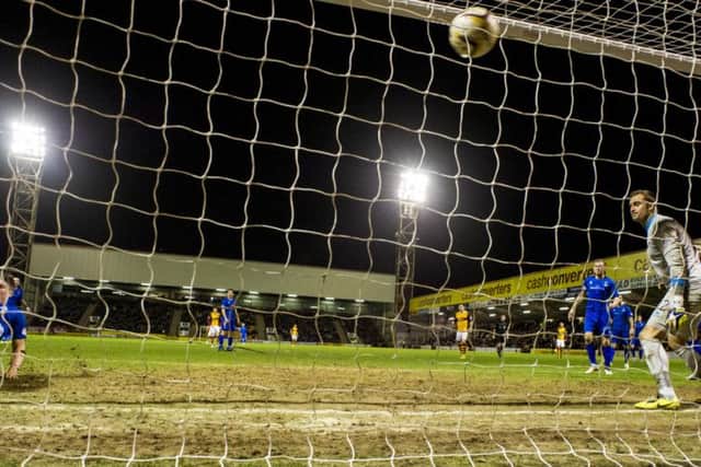 John Sutton  stoops low to head Motherwell into a 2-0 lead. Picture: SNS