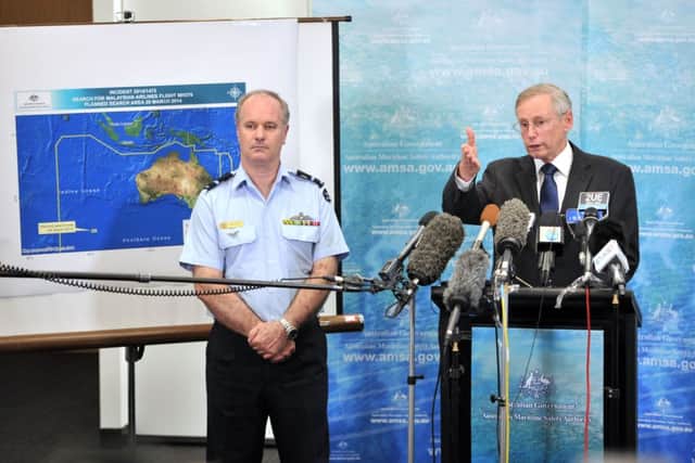 Air Commodore John McGarry (L) listens as John Young, Australian Maritime Safety Aiuthority emergency response general manager. Picture: Getty