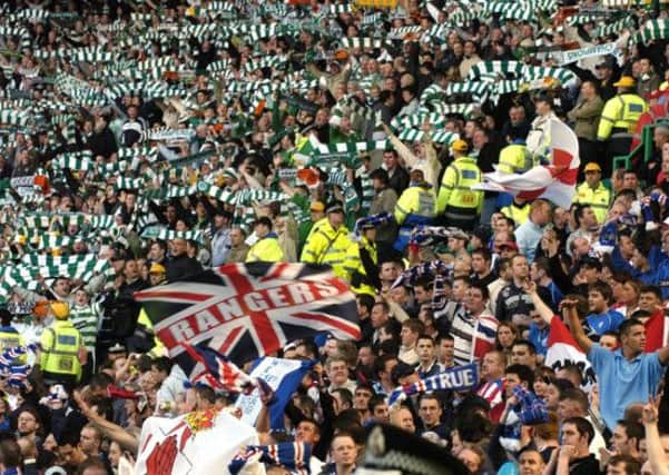 Celtic and Rangers fans at an Old Firm game in 2006. Picture: TSPL