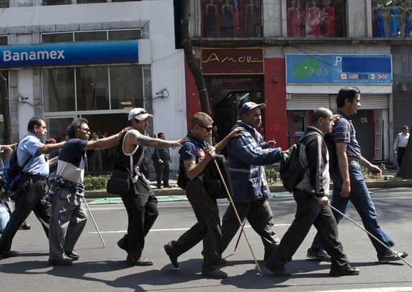 A group of blind vendors who worked on the Metro take part in a demonstration. Picture: AP