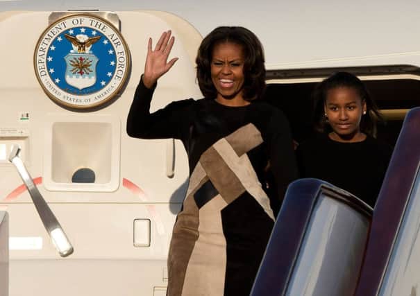 Michelle Obama steps off her official plane in Beijing, with daughter Sasha by her side. Picture: Getty Images