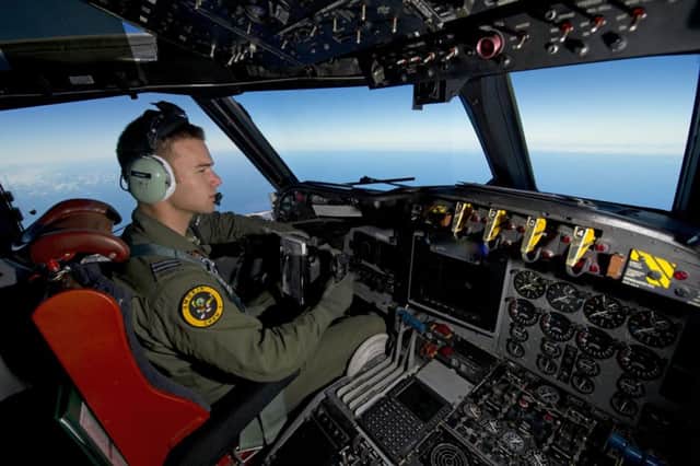 A Royal Australian Air Force pilot steers his AP-3C Orion over the search site. Picture: Reuters
