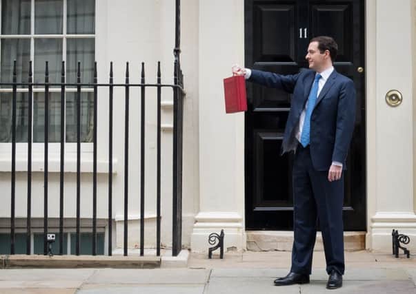 George Osborne poses for pictures holding the budget box yesterday. Picture: Getty