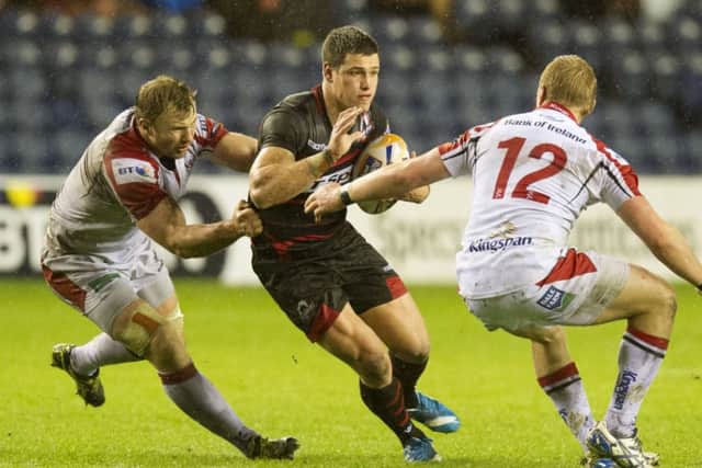 Edinburgh scrum half Grayson Hart tries to take on Roger Wilson (left) and Luke Marshall. Picture: SNS