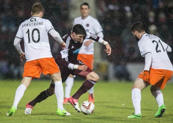 Callum Paterson takes on two Dundee United players. Picture: Ian Georgeson